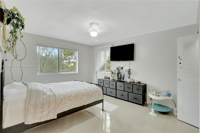 bedroom featuring ceiling fan and light tile patterned floors