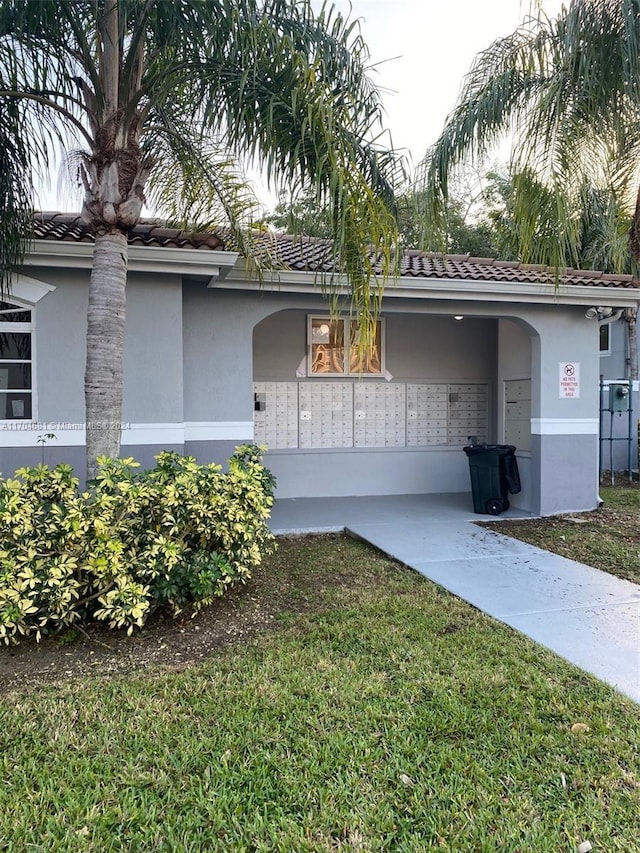 15400 SW 284th St Unit 1311, Homestead, FL 33033 - view of property exterior with mail area, stucco siding, and a tiled roof