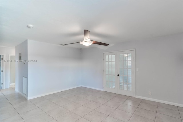 spare room with ceiling fan, french doors, and light tile patterned flooring