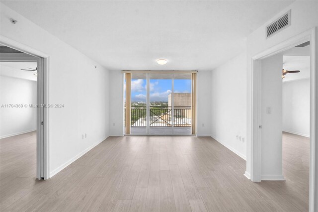 spare room with ceiling fan and light hardwood / wood-style flooring