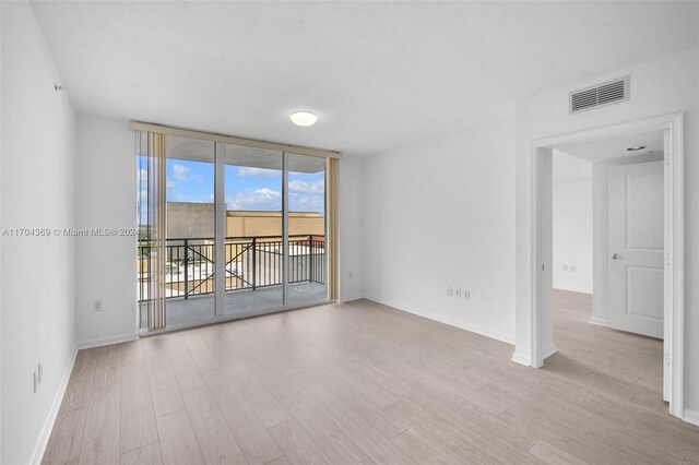 unfurnished room with light hardwood / wood-style floors