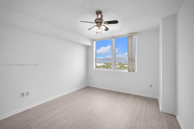 spare room featuring light hardwood / wood-style floors and ceiling fan