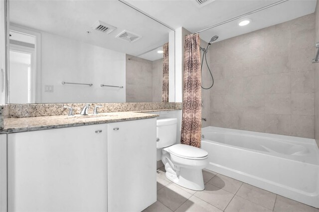 full bathroom with tile patterned flooring, vanity, shower / bath combo, and toilet