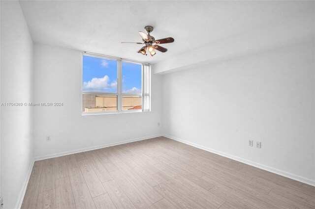 unfurnished room featuring hardwood / wood-style flooring and ceiling fan