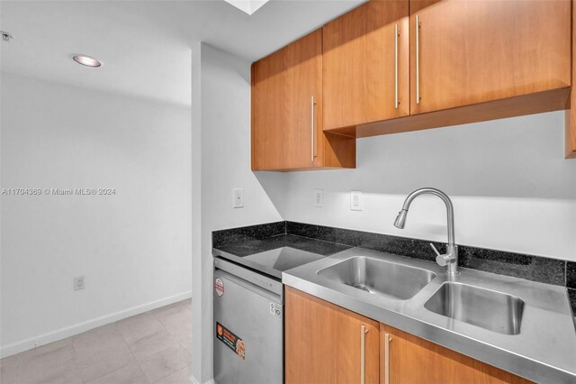 kitchen with dishwasher, light tile patterned flooring, and sink