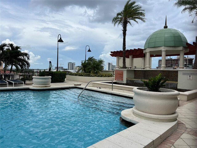 view of swimming pool with a pergola