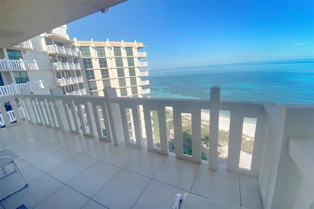 balcony featuring a beach view and a water view