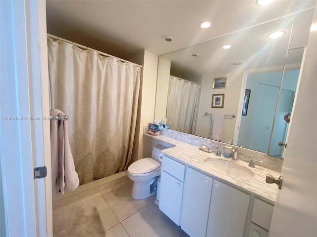 bathroom with tile patterned flooring, vanity, and toilet