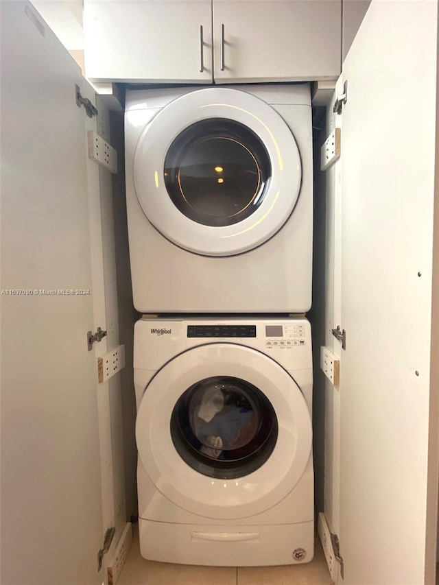 washroom featuring stacked washer / drying machine