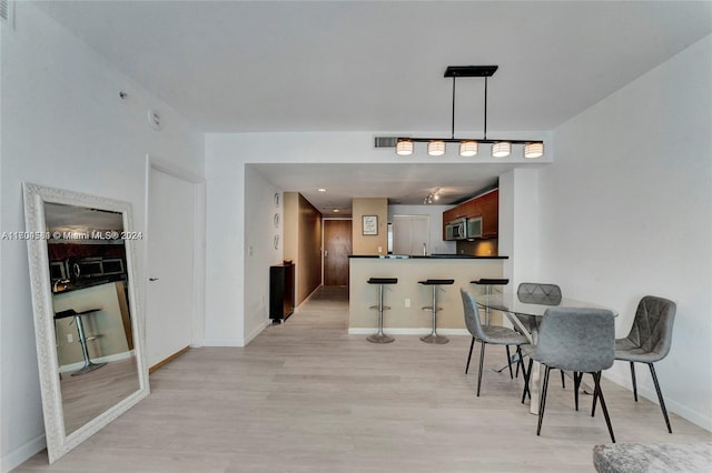 dining space featuring light hardwood / wood-style floors