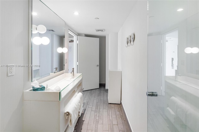 bathroom with hardwood / wood-style floors and vanity