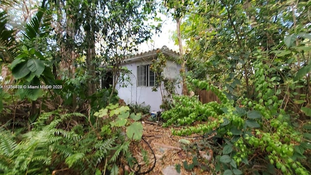 view of property exterior with a shed