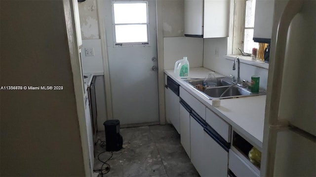 kitchen featuring white cabinets, white appliances, sink, and a wealth of natural light