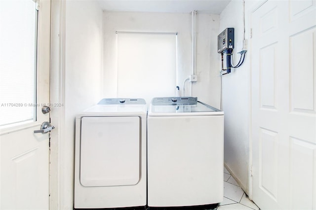 washroom with separate washer and dryer and light tile patterned floors