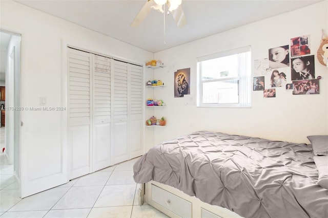 tiled bedroom featuring a closet and ceiling fan