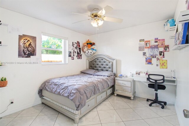 tiled bedroom featuring ceiling fan