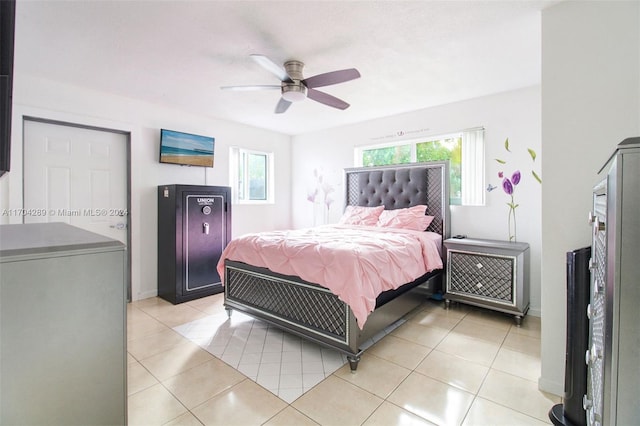 bedroom with multiple windows, ceiling fan, and light tile patterned floors