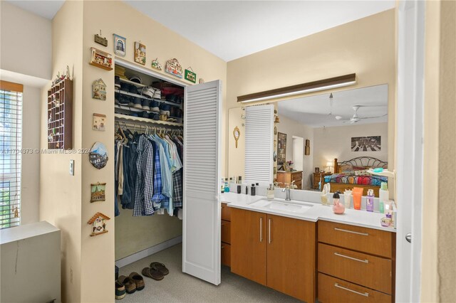 bathroom featuring ceiling fan and vanity