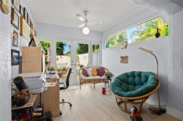 office space with ceiling fan, light hardwood / wood-style floors, and french doors