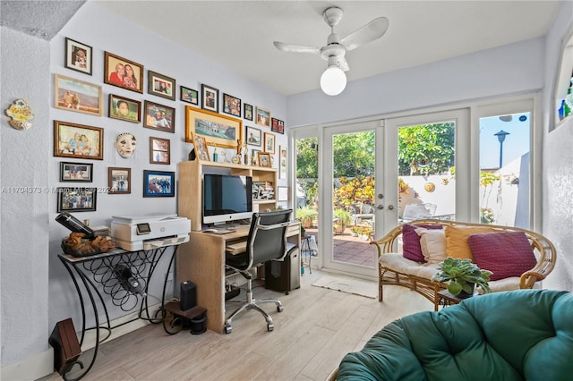 office with ceiling fan, french doors, and light hardwood / wood-style floors