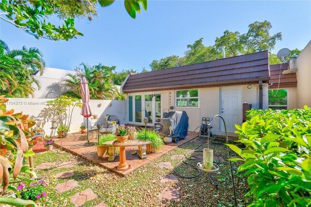 rear view of house featuring french doors and a patio