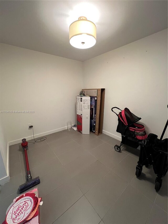 laundry area with stacked washer and clothes dryer