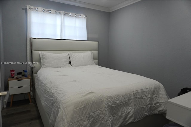 bedroom featuring dark hardwood / wood-style floors and ornamental molding