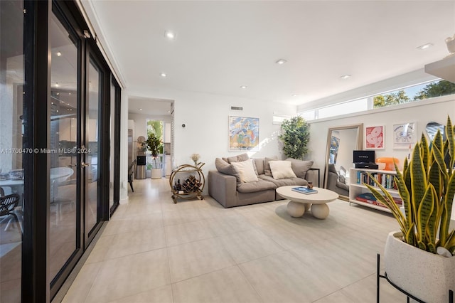 living room with french doors and light tile patterned floors