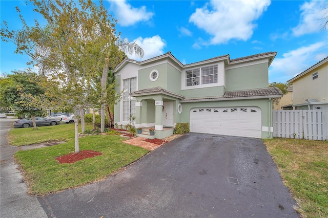 mediterranean / spanish-style house with a garage and a front lawn