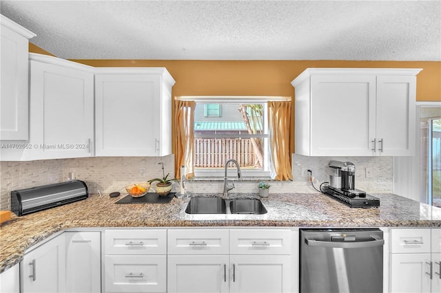 kitchen featuring dishwasher, white cabinetry, and plenty of natural light