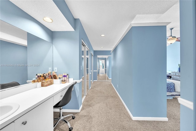 interior space featuring vanity and a textured ceiling