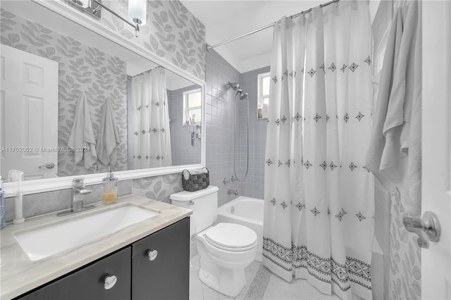 full bathroom featuring tile patterned flooring, vanity, toilet, and shower / tub combo with curtain