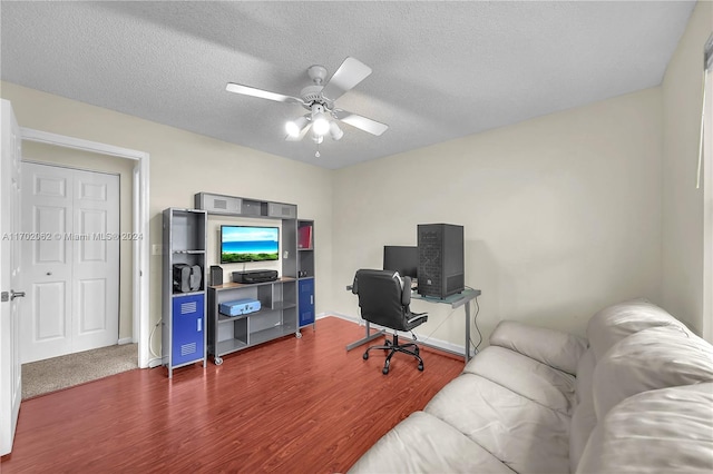 office area featuring a textured ceiling, dark hardwood / wood-style floors, and ceiling fan