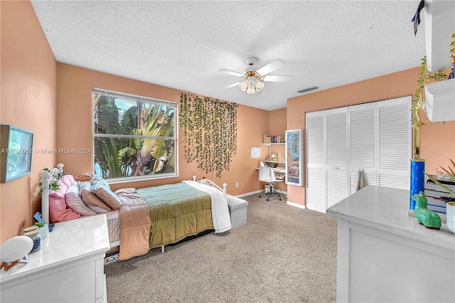 bedroom with ceiling fan, a closet, carpet floors, and a textured ceiling