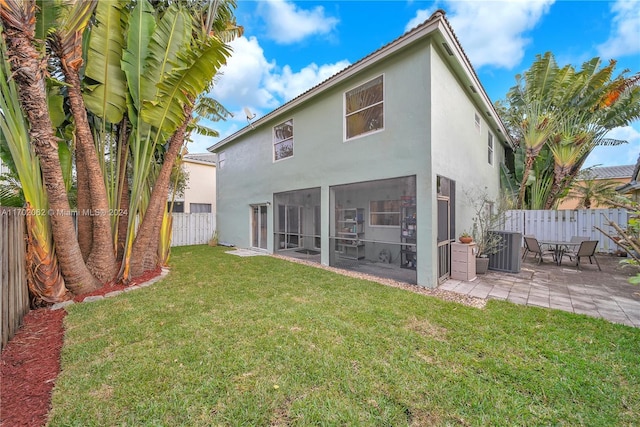 back of property featuring central AC, a sunroom, a yard, and a patio