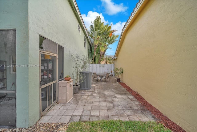 view of side of home with central AC and a patio area