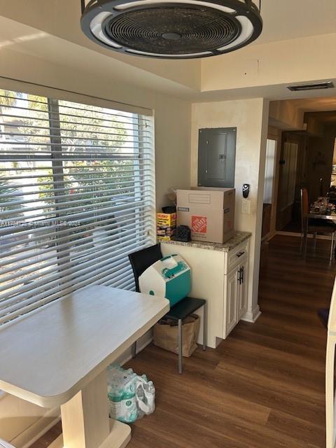 dining room featuring electric panel and dark hardwood / wood-style flooring