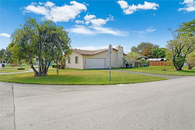 view of front of home with a garage and a front lawn