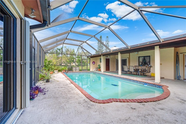 view of pool with a patio, ceiling fan, and a lanai