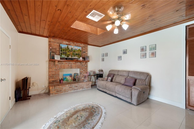 tiled living room featuring ornamental molding, a skylight, ceiling fan, and wooden ceiling