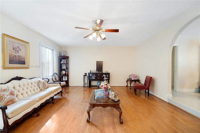 living room with light hardwood / wood-style floors and ceiling fan