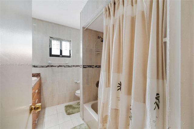 full bathroom with vanity, tile patterned floors, toilet, shower / bath combo with shower curtain, and tile walls