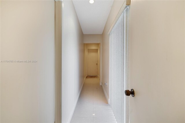 corridor featuring light tile patterned flooring