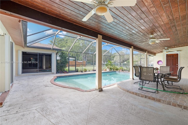 view of pool with a patio, ceiling fan, and a lanai