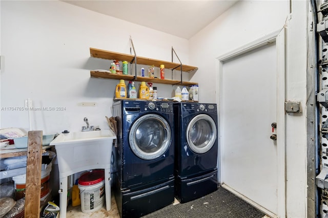 clothes washing area with washer and clothes dryer