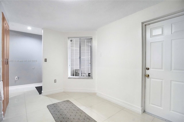 unfurnished room featuring light tile patterned floors