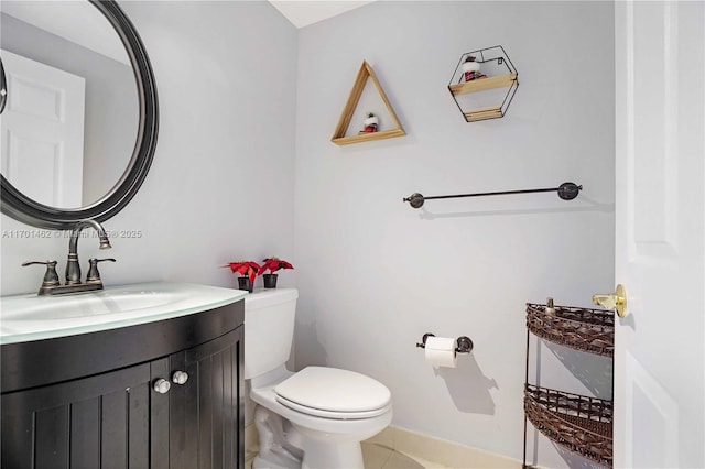 bathroom with vanity, tile patterned flooring, and toilet