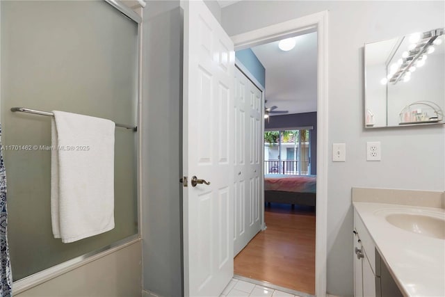 bathroom with vanity and a shower with door