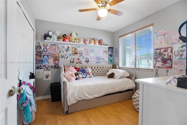 bedroom with ceiling fan, a closet, and light wood-type flooring