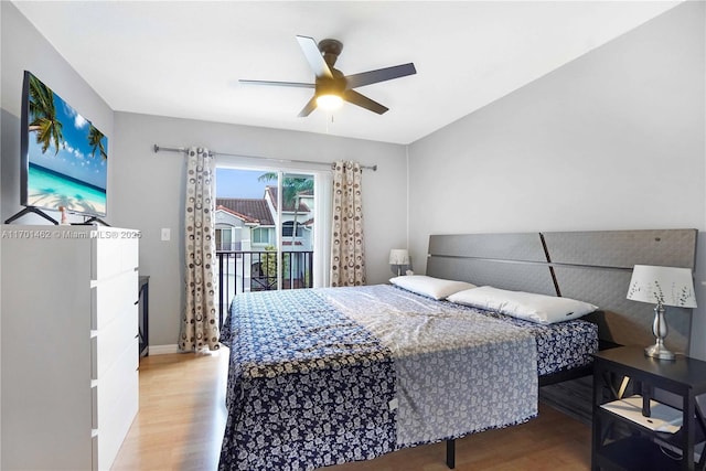 bedroom with hardwood / wood-style flooring, ceiling fan, and access to outside